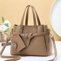 Detail of khaki lychee grain leather tote bag with matching coin purse and silver buckle - Tan