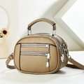 Detail view of brown multi-zip handbag featuring lychee texture and silver hardware - Khaki