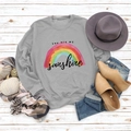 Flat lay of gray rainbow sweatshirt with Sunshine text on white wooden background - S / Grey (Black Print)