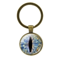 Detailed macro view of bronze dragon eye keychain featuring a vivid blue glass dome iris - Dark Blue Cat Eye (JY001574-6)