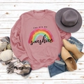 Detailed flat lay of pink long-sleeve sweatshirt with rainbow print and sunshine text - S / Rose Gold (Black Letters)