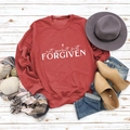 Flat lay of rust-red long sleeve sweatshirt with Not Perfect Just Forgiven text print - S / Red Sweatshirt (White Font)