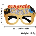 Close-up of glittery graduation party glasses with red Congrats Grad text and mortarboard decor - Congrats Graduation Style