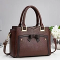 Minimalist chocolate brown leather tote bag with bow detail and gold hardware accents - Coffee