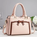 Elegant pale pink minimalist tote bag with contrast trim and bow detail in a studio setting - Pink