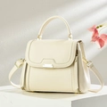 Minimalist cream leather handbag with top handle and gold hardware on a modern podium - Off White