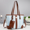 Blue striped tote bag set with brown leather trim and matching small pouch on a white desk - Light Blue