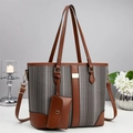 Detail of grey striped tote bag set with brown leather trim and matching small pouch - Black