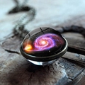 Macro shot of galaxy glass ball pendant with purple nebula design on a rustic wood surface - Purple Vortex Galaxy Style (JY001624-10)