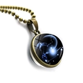 Detailed close-up of a Capricorn zodiac pendant with bronze frame and blue glass sphere - Bronze-Capricorn