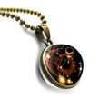 Macro detail of antique bronze Leo zodiac necklace with double-sided glass orb and star map - Bronze-Leo