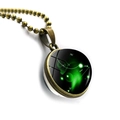 Macro shot of Aries zodiac pendant with green nebula glass ball and antique bronze chain - Bronze-Aries