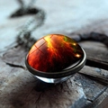 Macro shot of cosmic nebula pendant with double-sided glass dome on vintage wood - Orange Red Green Nebula(JY001706-3)