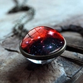 Macro detail of cosmic nebula glass cabochon pendant on vintage bronze metal base - Red Black Nebula(JY001706-9)