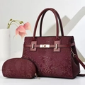 Detailed macro view of wine red snakeskin texture and gold metal buckle on a tote bag - Burgundy