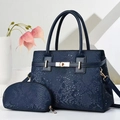 Close-up of deep blue snake-embossed leather tote bag with elegant gold metal clasp detail - Blue
