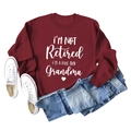 Close-up of I'M A FULL-TIME Grandma typography on a wine red long sleeve sweatshirt - S / Burgundy