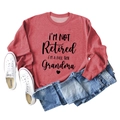 Flat lay of a red long sleeve sweatshirt featuring a funny Grandma slogan and denim jeans - S / Red (Black Font)