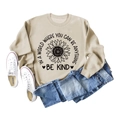 Beige crewneck sweatshirt with sunflower print and 'Be Kind' quote paired with blue jeans - S / Sand Sweatshirt (Black Text Pattern)