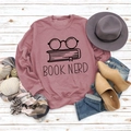 Flat lay of vintage red sweatshirt with Book Nerd print and autumn fashion accessories - S / Rose Gold (Black Font)