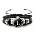 Detail of woven leather bracelet with letter L glass cabochon and metal beads - Letter L