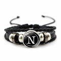 Macro detail of retro multi-layer braided leather bracelet with letter N glass gemstone - Letter N