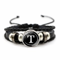 Detailed macro view of multilayer leather bracelet featuring letter T glass charm pendant - Letter T