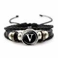 Detailed shot of multilayer leather bracelet featuring letter V glass dome and metal beads - Letter V