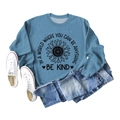 Detail of blue crewneck sweatshirt with sunflower print and Be Kind slogan - Blue Sweatshirt (Black Text Pattern)