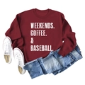 Flat lay of burgundy crewneck sweatshirt with Weekends Coffee Baseball text and jeans - Burgundy