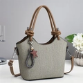 Minimalist grey-green pleated tote bag with brown leather handles and star charm on desk - Gray