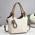 Detailed view of the embossed texture and stylish star pendant on a beige tote bag - Off White