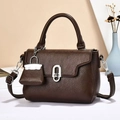 Detail of dark brown lychee leather handbag with silver oval twist lock and mini pouch - Coffee