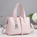Detail of pink faux leather handbag featuring silver LR pendant and dual handles - Pink (A96254)