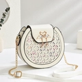 Creamy white round crossbody bag with geometric cutouts and swan metal buckle - 18cmx17cmx9cm / Off White