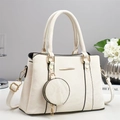 Detail view of cream handbag with gold hardware, adjustable strap and round coin purse - Off White