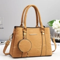 Elegant khaki faux leather handbag with gold hardware and a small round coin purse charm - Earthy Yellow