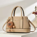 Elegant beige leather handbag with quilted patterns and a plush charm for daily commuting - Khaki