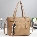 Detail view of khaki large capacity tote bag with decorative sneaker charm and shoulder strap - Khaki