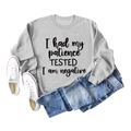 Vue à plat d'un sweat gris à manches longues avec slogan 'I had my patience TESTED' - S / Gris