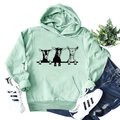 Flat lay of mint green hoodie with goat print, styled with blue jeans and sneakers - Light Green