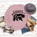 Detailed flat lay of pink Grandma Bear sweatshirt with black graphic print and autumn decor - S / Pink (Black Text)