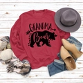 Flat lay of red Grandma Bear sweatshirt with autumn accessories on white wood - S / Red (Black Text)