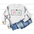 Flat lay of gray long sleeve sweatshirt with colorful Speech Therapy print and heart - White (Black Letters)