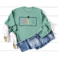 Flat lay of mint green long sleeve sweatshirt with colorful SPEECH therapy print design - Light Green (Black Print)