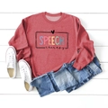 Flat lay of red long sleeve sweatshirt with Speech Therapy print and denim jeans - Red (Black Print)