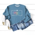 Detail of blue crewneck sweatshirt with Speech Therapy print on wooden background - Blue (White Print)