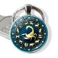 Silver Scorpio zodiac keychain with blue star glass dome and gold scorpion symbol - Scorpio