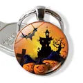 Close-up of Halloween glass pendant keychain featuring pumpkin and castle illustrations - Pumpkin & Gothic Castle (JY002534-2)