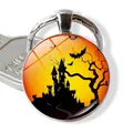 Halloween keychain with a round glass dome featuring a castle, bats, and sunset scenery - Castle & Bats at Sunset (JY002534-10)
